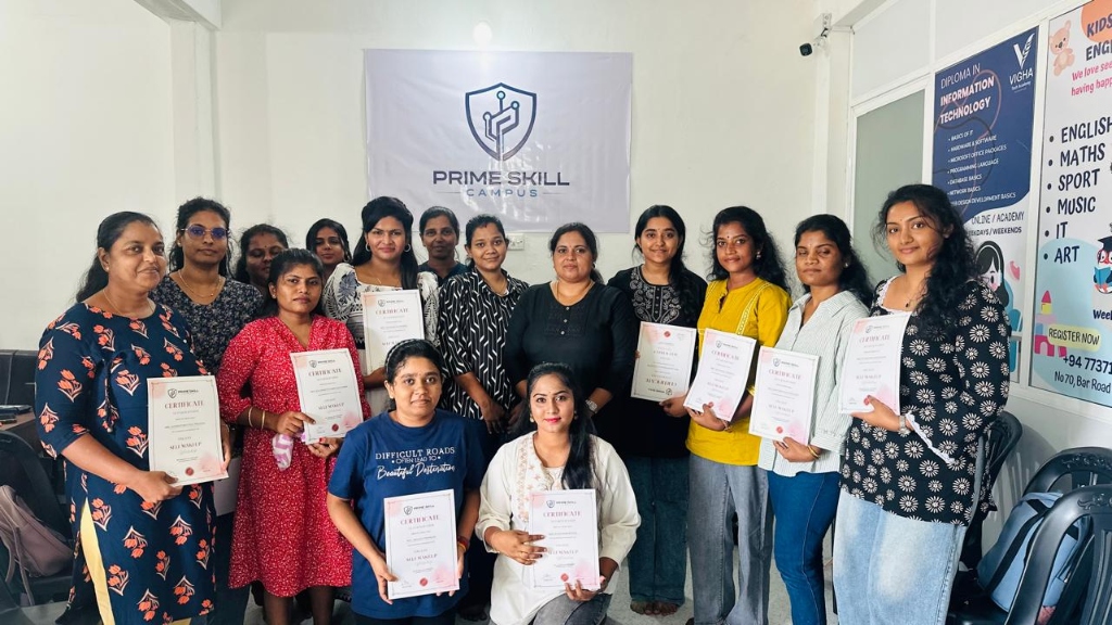 Real graduates proudly holding certificates in front of the Prime Skill Campus wall banner in Arasady, Batticaloa